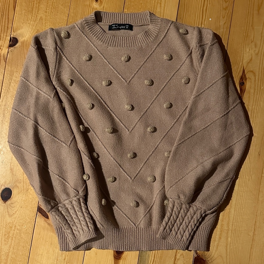 Women taupe puff sleeve sweater with adorable pompom bubbles. Cable knit cuffs.